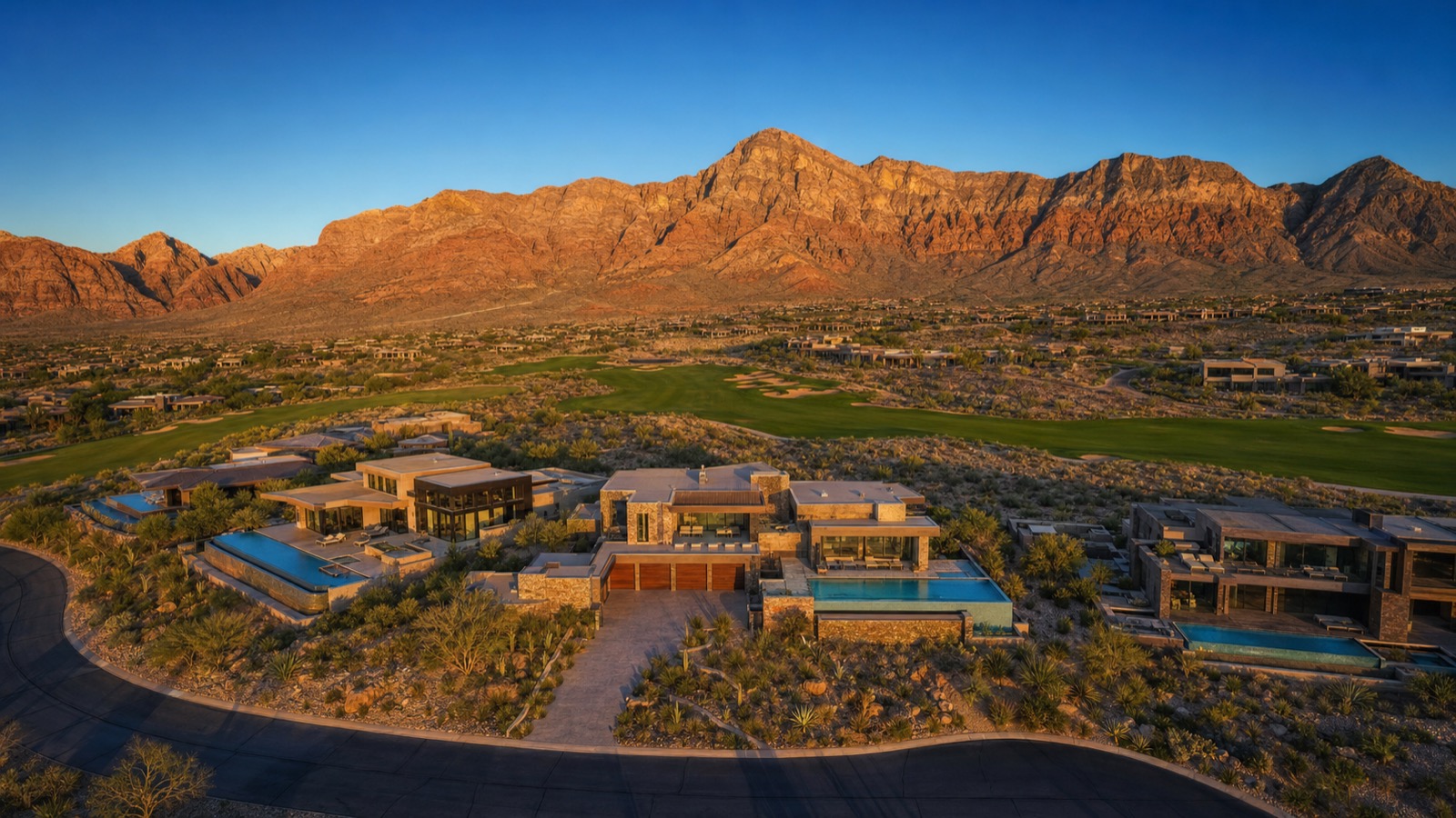 The Summit Club Summerlin Tiger Woods designed private golf course aerial view at golden hour with Red Rock Canyon backdrop